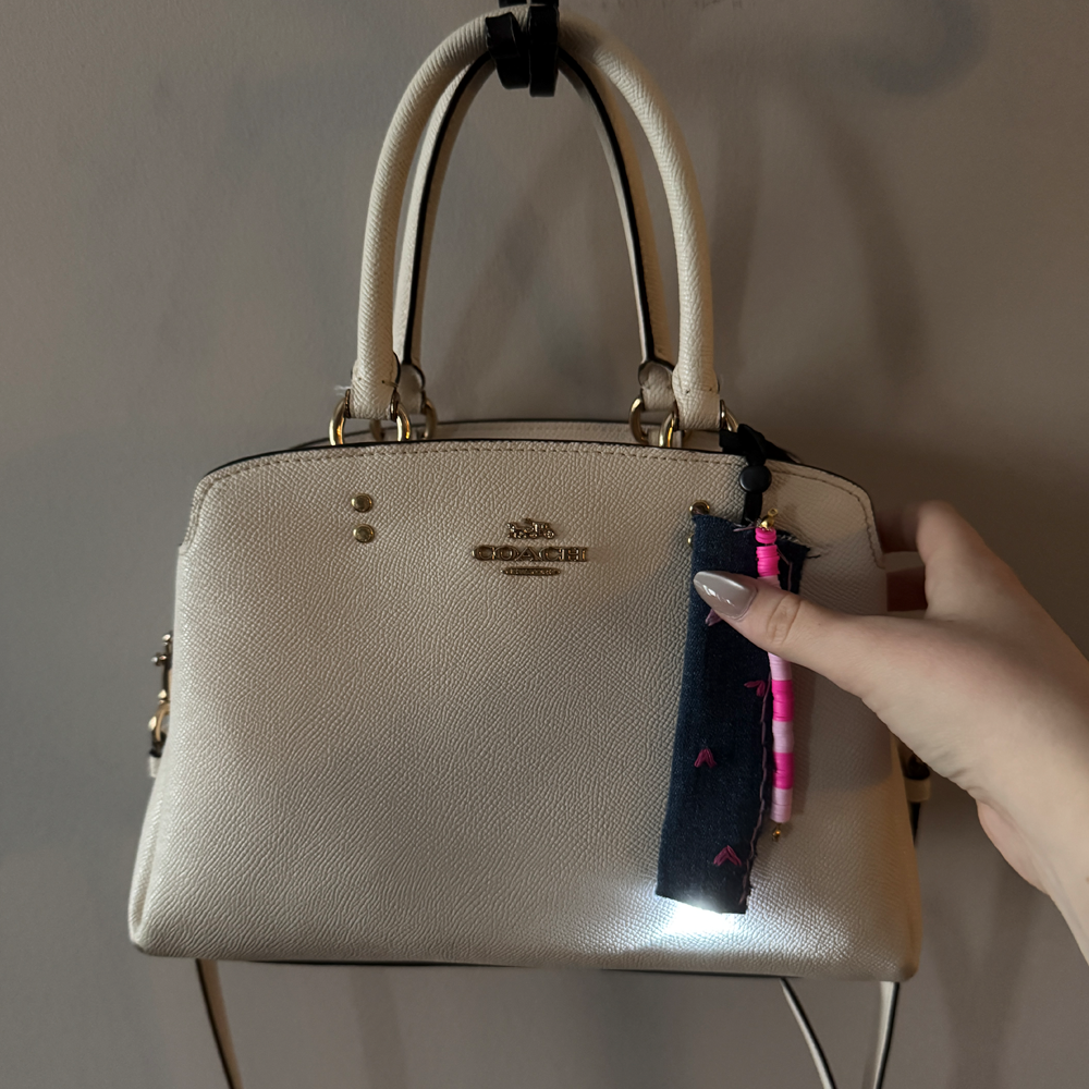 This picture shows me pressing on the big heart on the keychain to activate the light on the end of it. The light is triggered by pressure so when it is not being pressed on it is off and when it is pressed it will turn on.